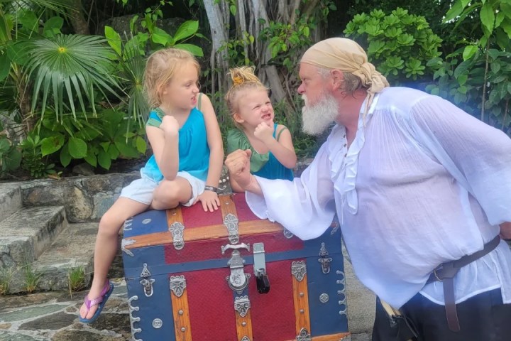 a man standing next to a tree