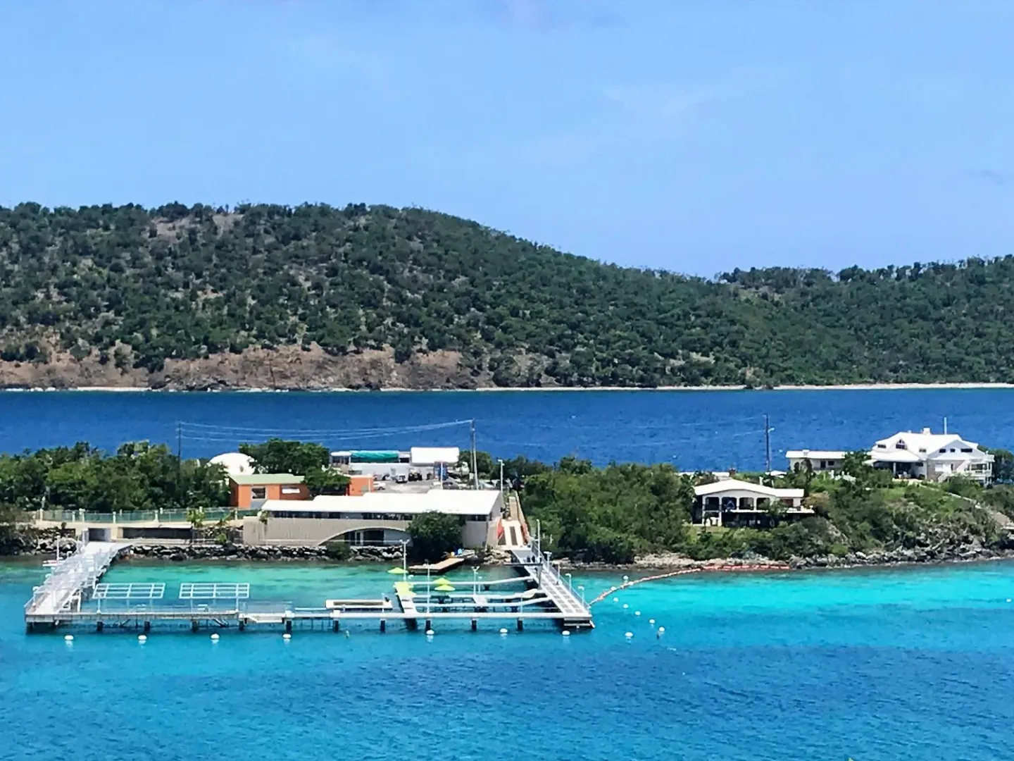 a blue and white boat sitting next to a body of water