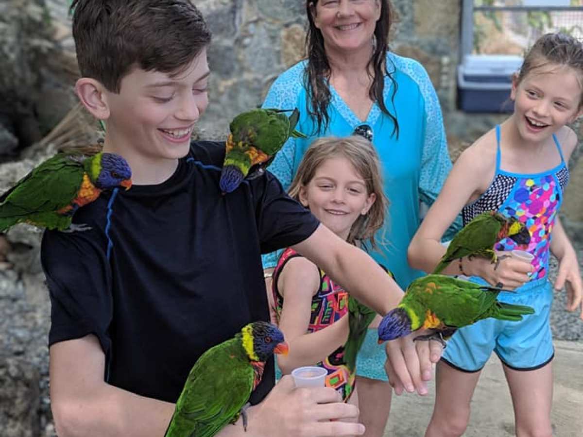 a group of people standing next to a child