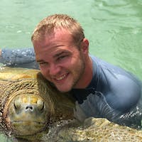 a man holding a fish in the water