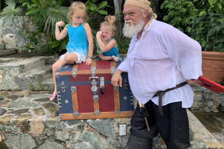 a little girl standing in front of a building