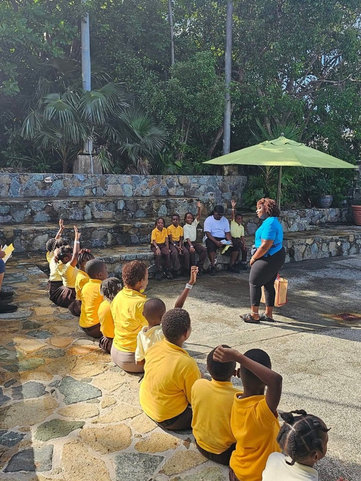 a group of people sitting at a zoo